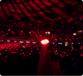 Concert crowd holding LED wristbands glowing red